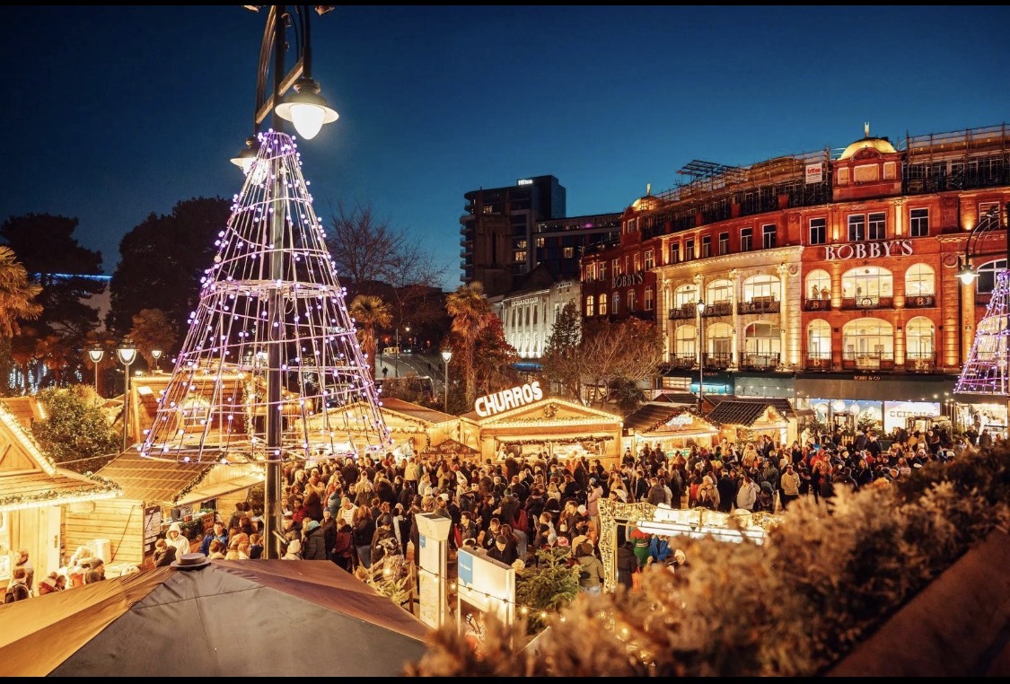 An illuminated Christmas tree outside the shops in Bournemouth town centre at dusk